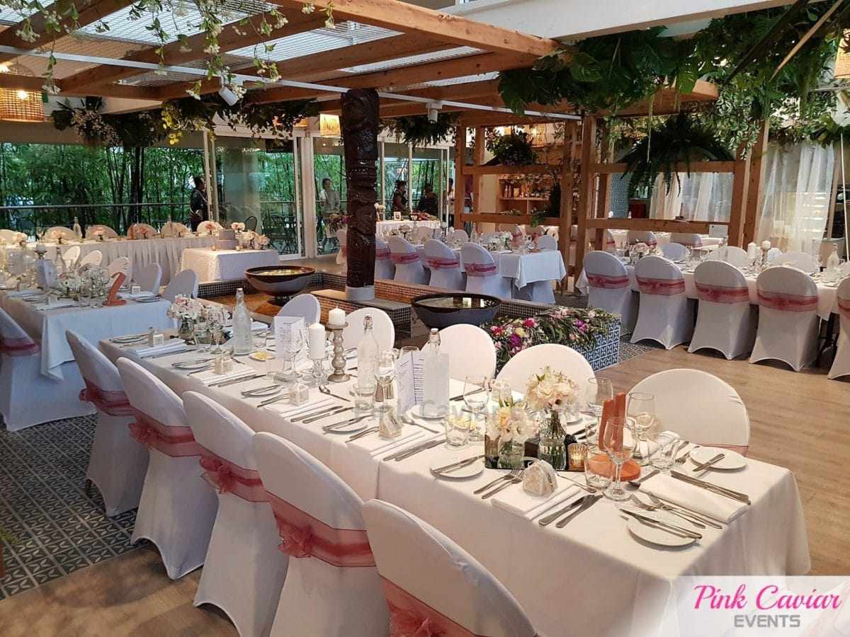 Pink sash chair covers indoor garden wedding reception with silver stick candle holders An Evening Pack Down Service Wedding Styling