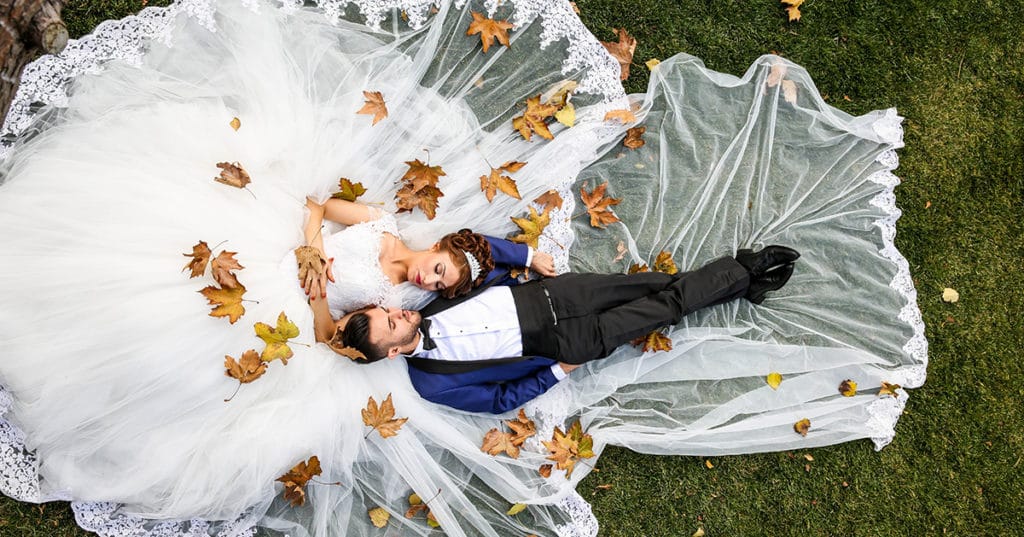 Bride Groom lying down in park Winter Wedding
