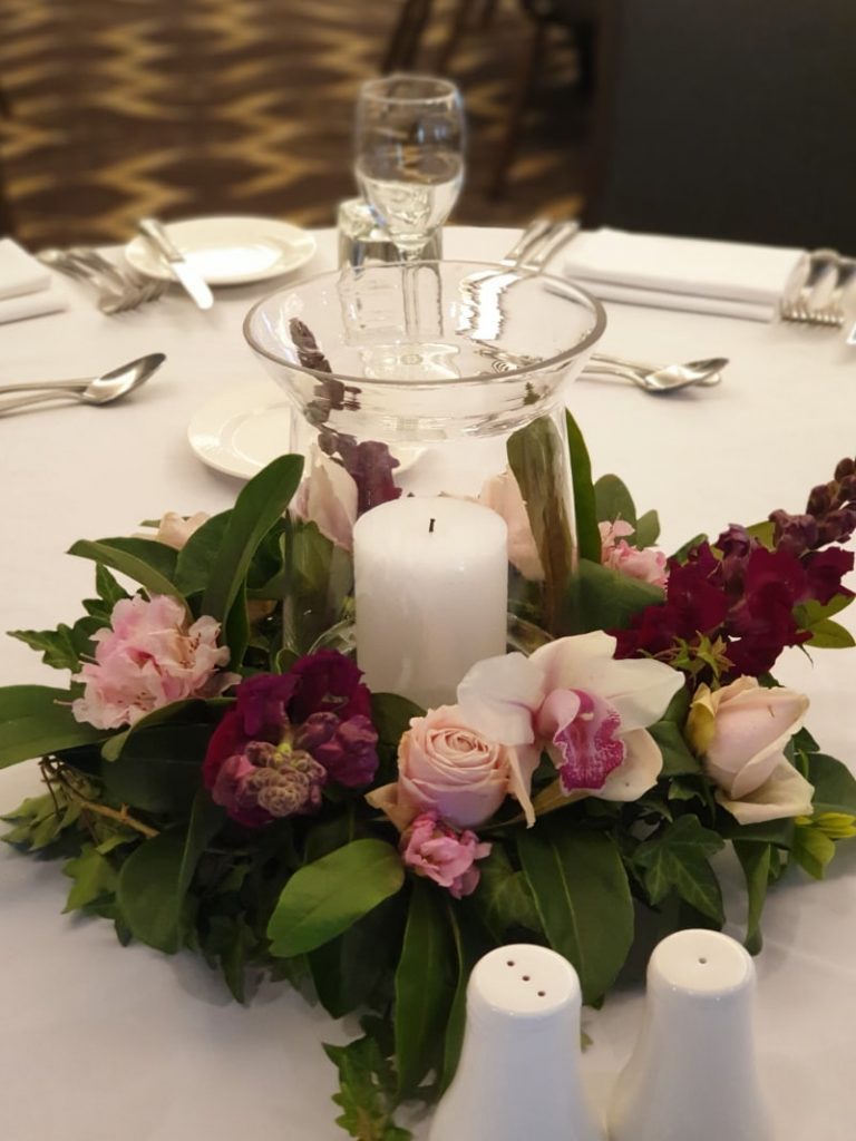 hurricane-vase-with-pillar-candle-and-flower-wreath-hurricane-vase-with-pillar-candle-and-flower-wreath-centrepiece-pink-caviar-events