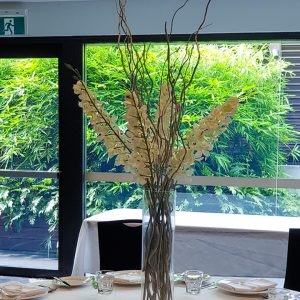 Tall orchids and willow centrepiece