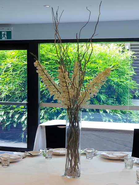 Tall orchids and willow centrepiece