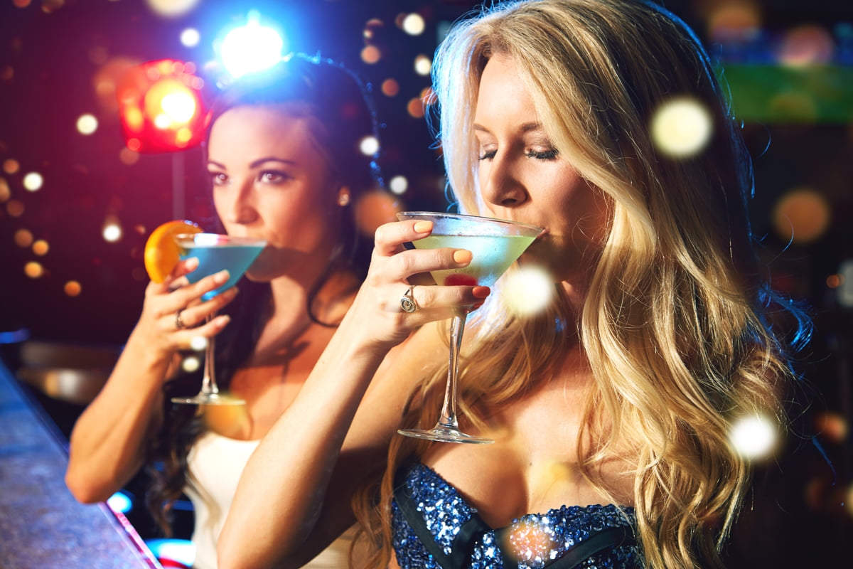 Women, cocktail and drink at party or nightclub, celebrate new year with alcohol drinks, friends and drinking together. Celebration, fun at happy hour with social and holiday event with cocktails. End-of-Year Celebrations, end of year celebrations