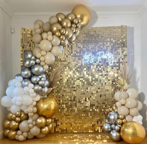 gold shimmer wall with balloon garland