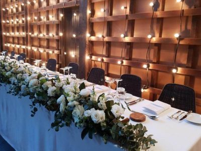 Wedding Bridal Table with White Floral Runner and Lights